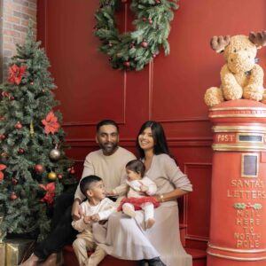 Winter holiday indoor photoshoot with tree ornaments and cozy setup