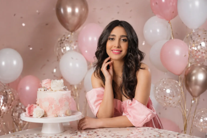 Professional birthday photoshoot studio in Toronto with pink balloon decor and elegant cake