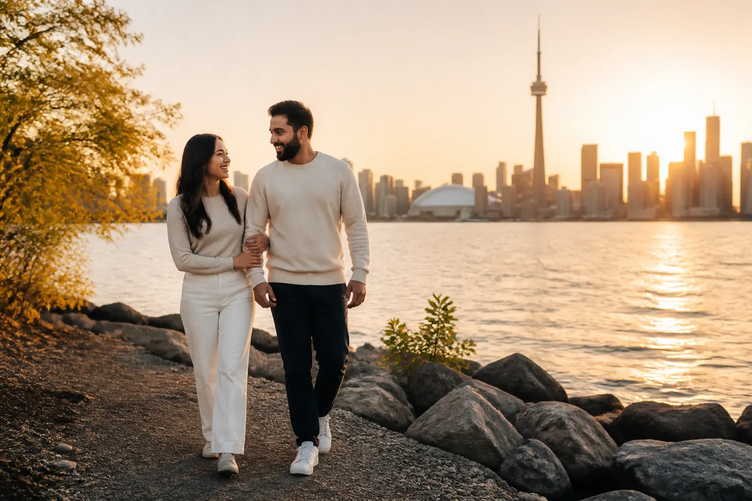 Couple walking by the Toronto waterfront during a golden-hour pre-wedding photoshoot