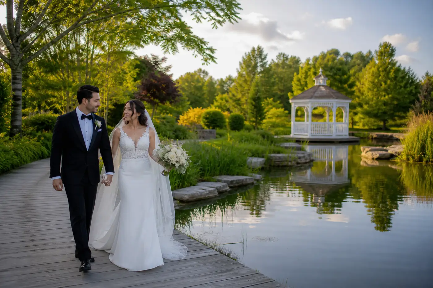 Wedding couple beside a landscaped pond and gazebo near Vaughan
