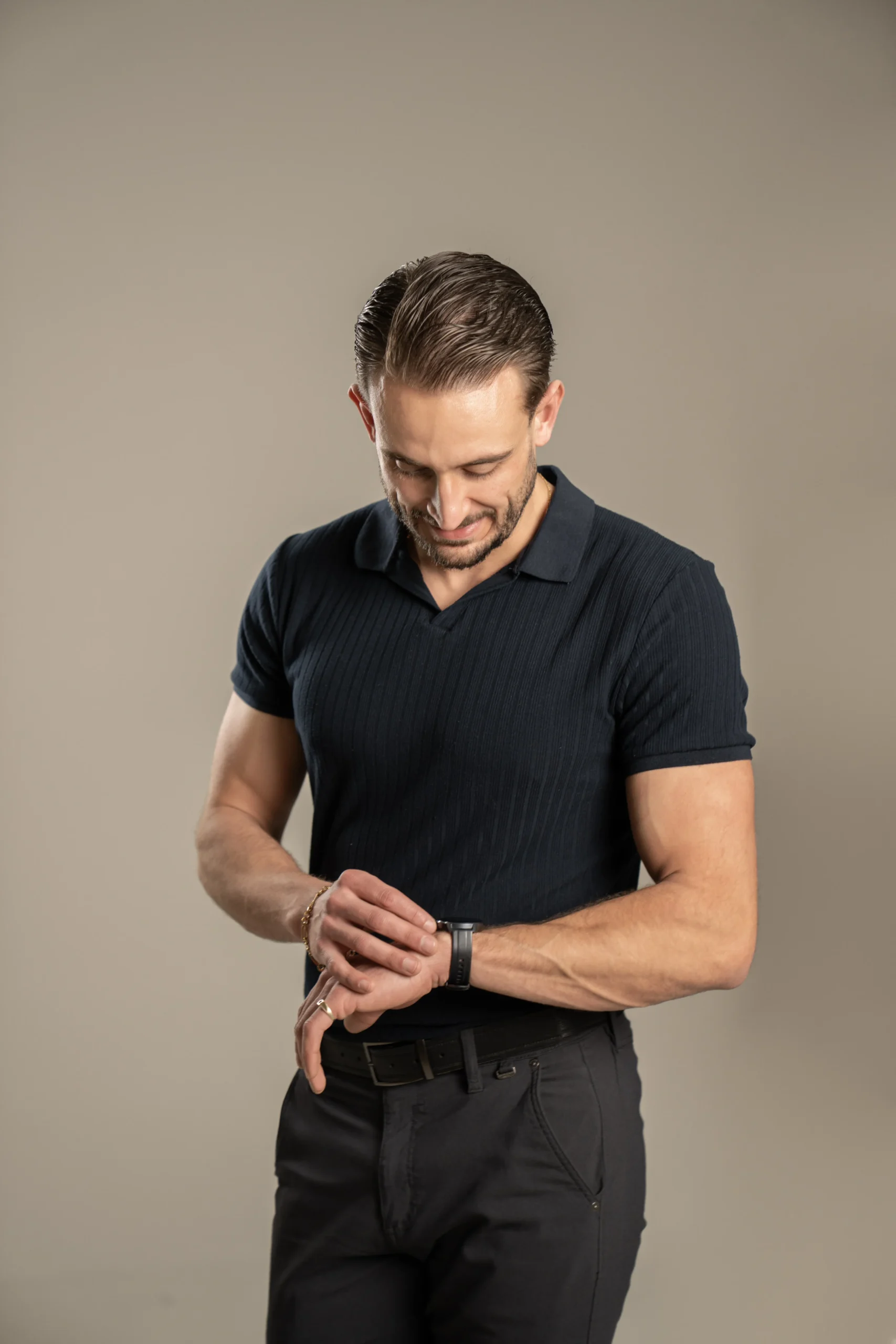 Male professional checking his watch during a modern studio branding portrait