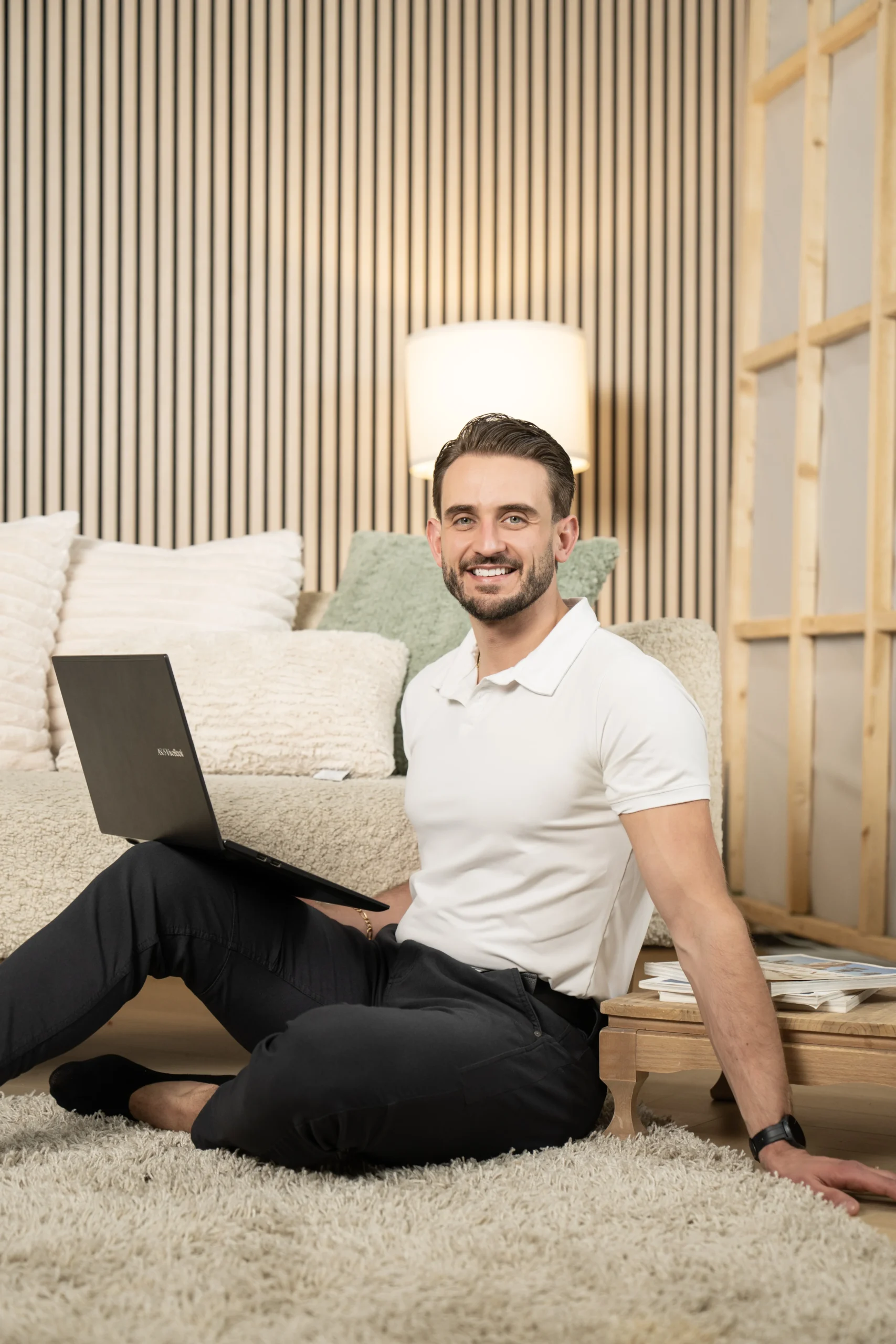 Male entrepreneur seated with a laptop during a Toronto personal branding portrait session