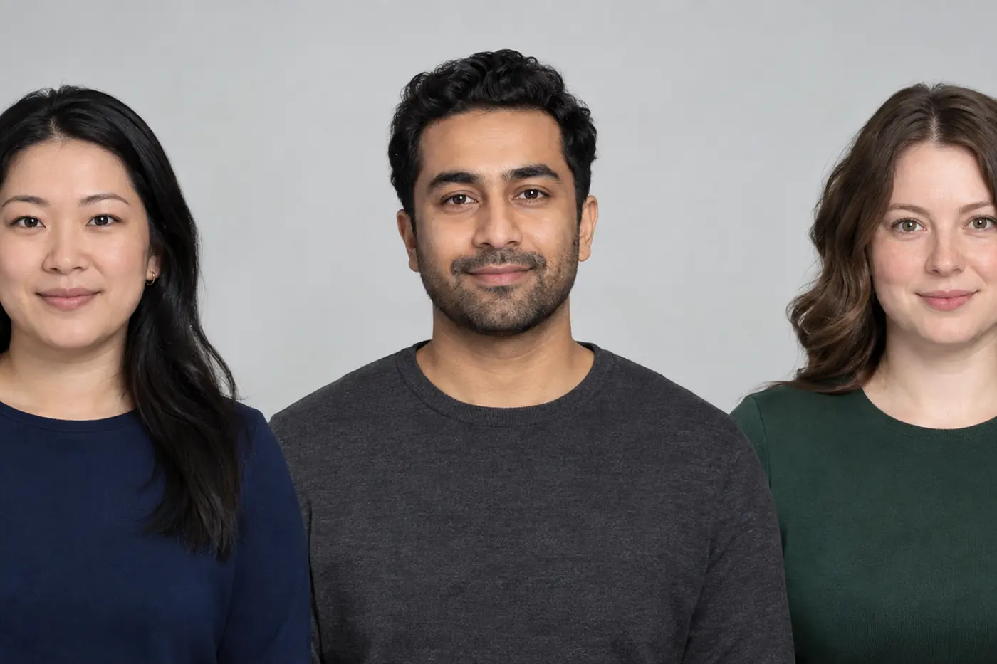Three adults wearing navy, charcoal and green tops for Canadian passport photos