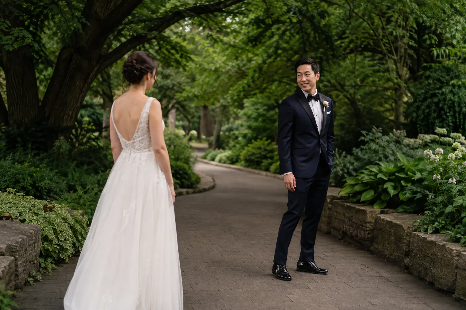 Wedding first look on a tree-lined path at Edwards Gardens