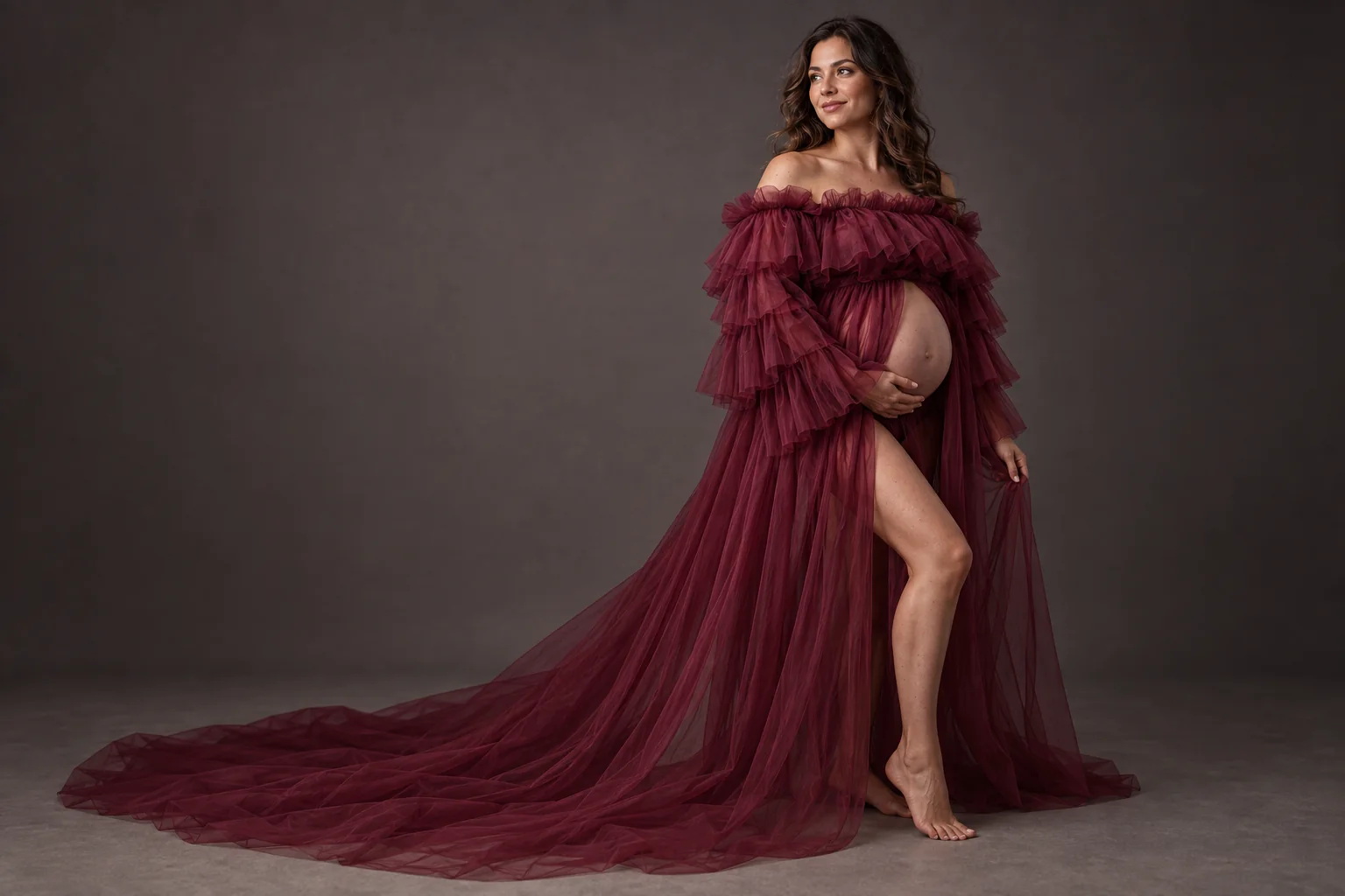 Pregnant client wearing a free burgundy tulle maternity dress in Toronto studio